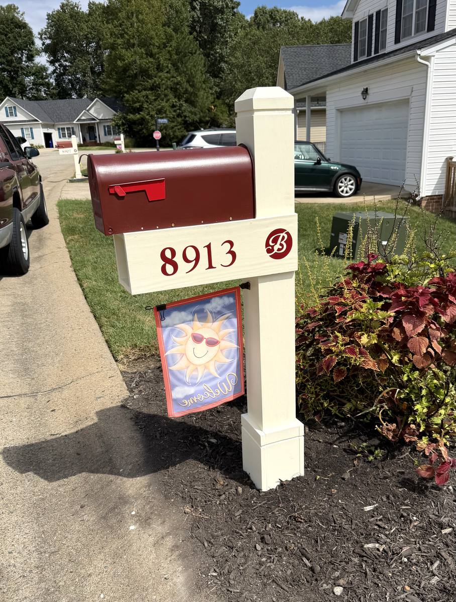 Custom HOA mailbox, cream post with burgundy box and community monogram